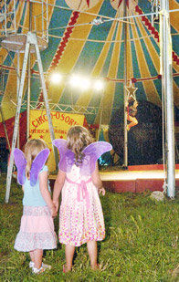 Two girls with fairy wings inside the Circus Osorio tent. Neither is me. That can't be me. I don't remember being there.